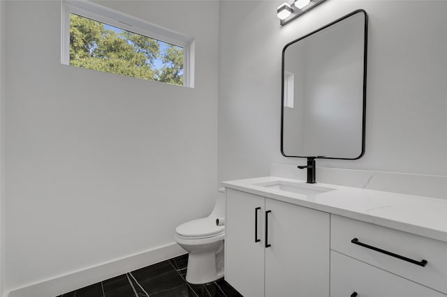 bathroom featuring toilet and vanity