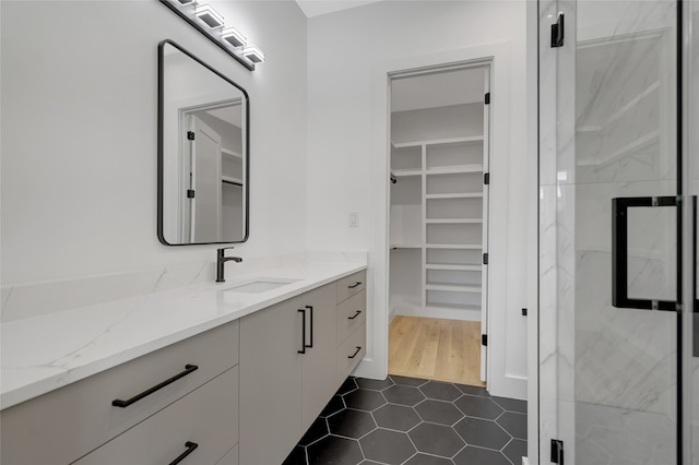 bathroom with vanity, tile patterned flooring, and a shower with door