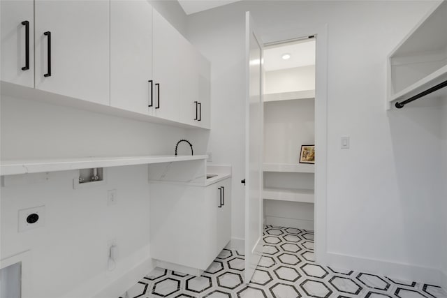 laundry area featuring washer hookup, hookup for an electric dryer, and cabinets