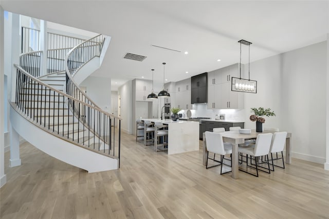 dining space featuring a notable chandelier and light hardwood / wood-style flooring