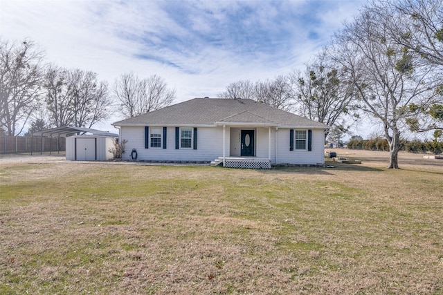 single story home with a front yard, a storage shed, and a carport