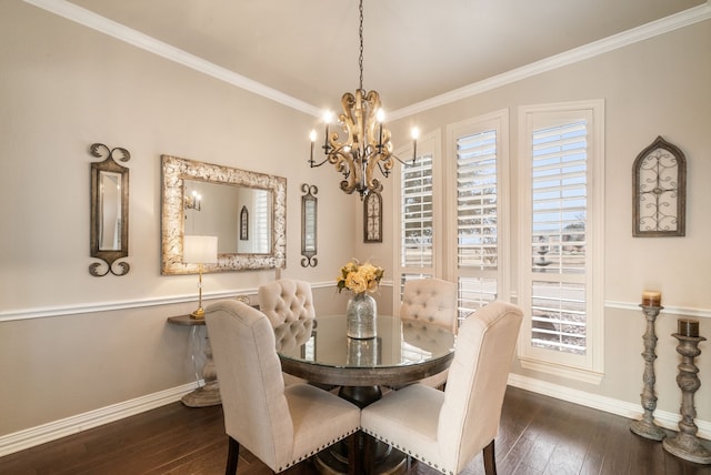 dining area featuring dark hardwood / wood-style flooring, ornamental molding, and a chandelier