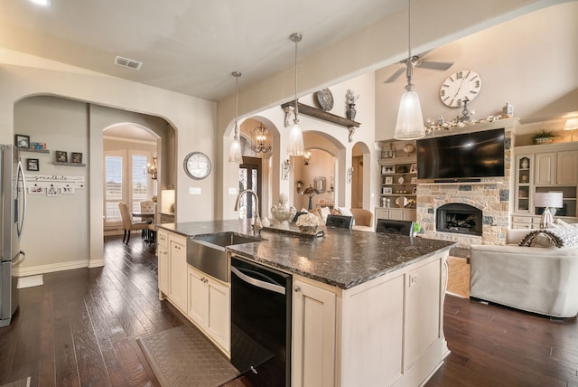 1901 Yucatan Dr, Granbury, TX 76048 - kitchen with black dishwasher, a sink, arched walkways, and a center island with sink