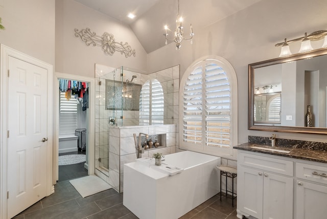 bathroom featuring lofted ceiling, vanity, a notable chandelier, tile patterned floors, and independent shower and bath