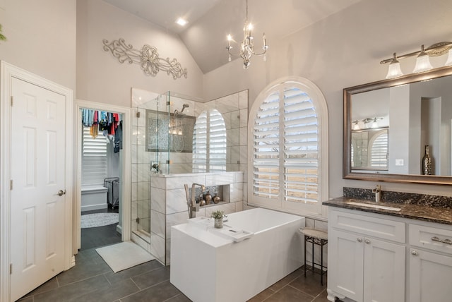 1901 Yucatan Dr, Granbury, TX 76048 - full bathroom featuring a shower stall, vaulted ceiling, a freestanding bath, tile patterned flooring, and vanity