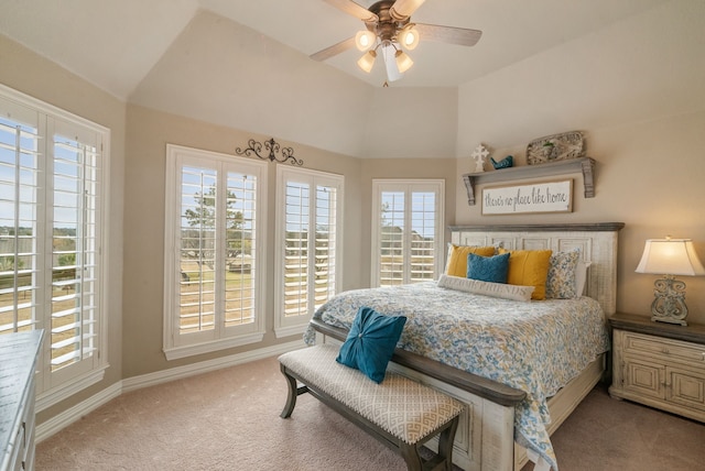 carpeted bedroom featuring ceiling fan, multiple windows, and lofted ceiling