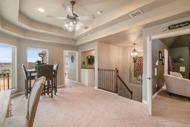 1901 Yucatan Dr, Granbury, TX 76048 - dining area featuring light carpet, a tray ceiling, a chandelier, baseboards, and a ceiling fan