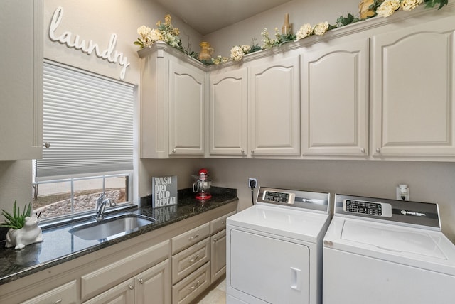 washroom featuring cabinets, sink, and washing machine and dryer