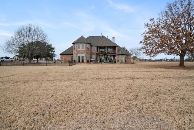 rear view of house with a lawn