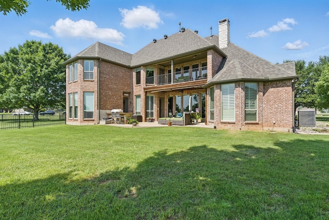 1901 Yucatan Dr, Granbury, TX 76048 - rear view of house with a balcony, brick siding, an outdoor living space, a patio area, and a chimney