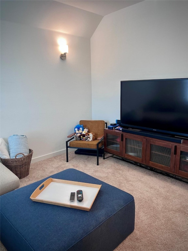 carpeted living room with vaulted ceiling