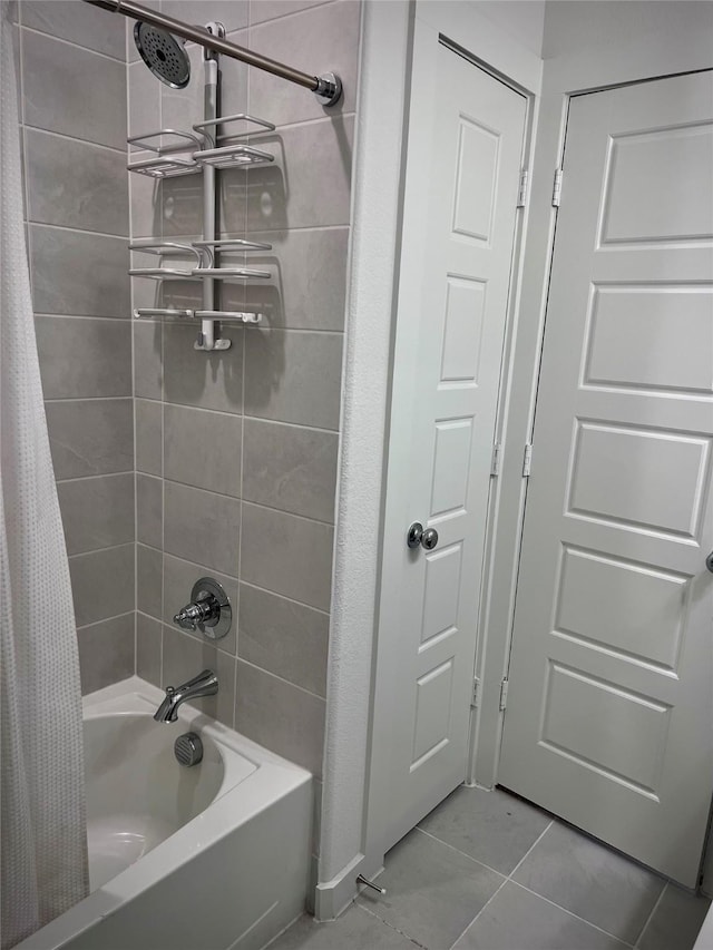 bathroom with tile patterned flooring and shower / bath combo