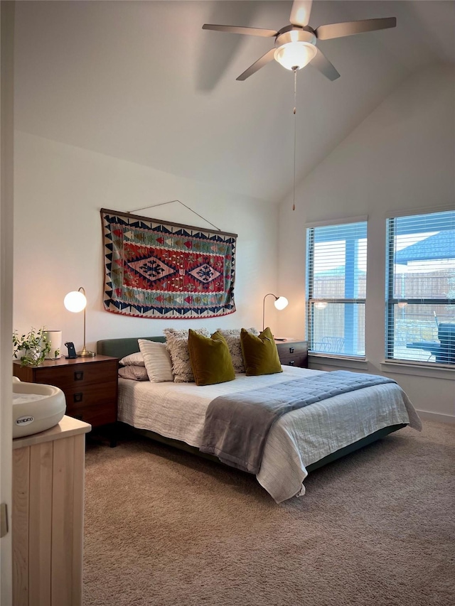 carpeted bedroom featuring ceiling fan and vaulted ceiling