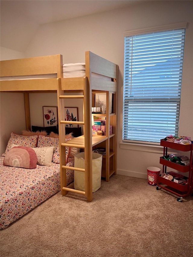 bedroom featuring vaulted ceiling and carpet flooring