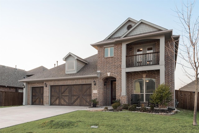 view of front of property with a balcony, a garage, and a front yard