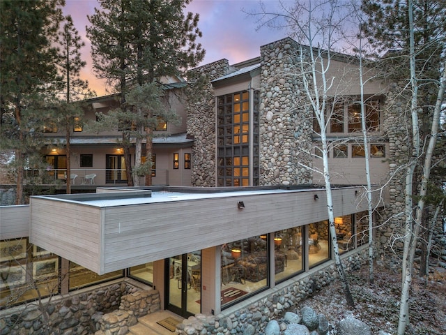 view of back house at dusk