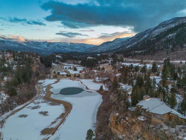 snowy aerial view with a mountain view