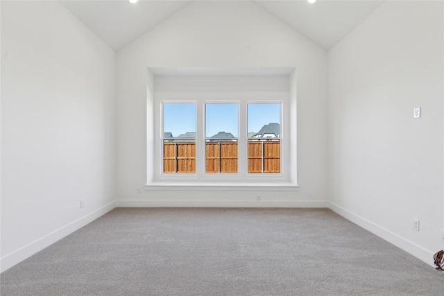 unfurnished room featuring high vaulted ceiling, carpet flooring, and baseboards