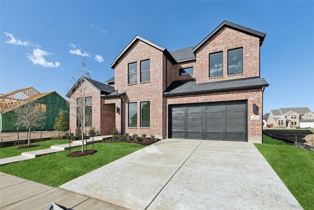 view of front of property featuring driveway, brick siding, a front lawn, and an attached garage