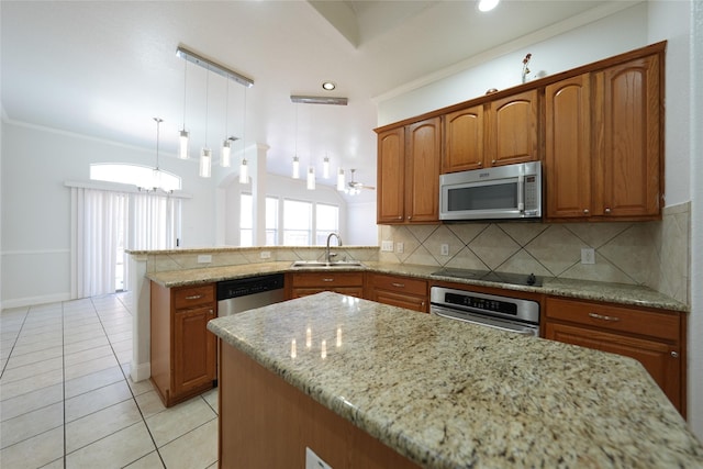 kitchen with sink, hanging light fixtures, backsplash, stainless steel appliances, and kitchen peninsula