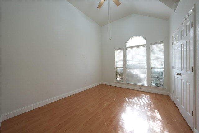 unfurnished room featuring ceiling fan, high vaulted ceiling, and light hardwood / wood-style floors