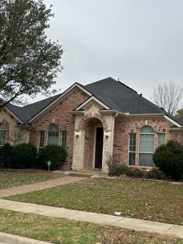 obstructed view of property with a front yard