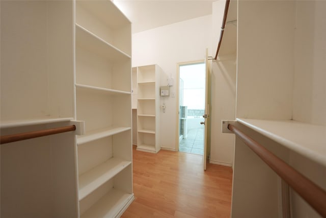 walk in closet featuring light hardwood / wood-style flooring