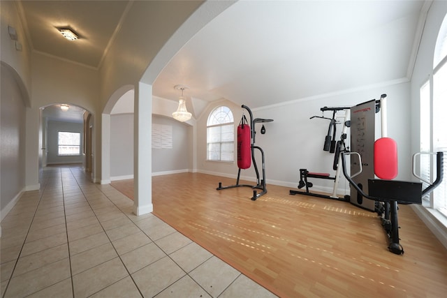 exercise area featuring ornamental molding and light wood-type flooring