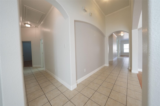 corridor with light tile patterned flooring and ornamental molding