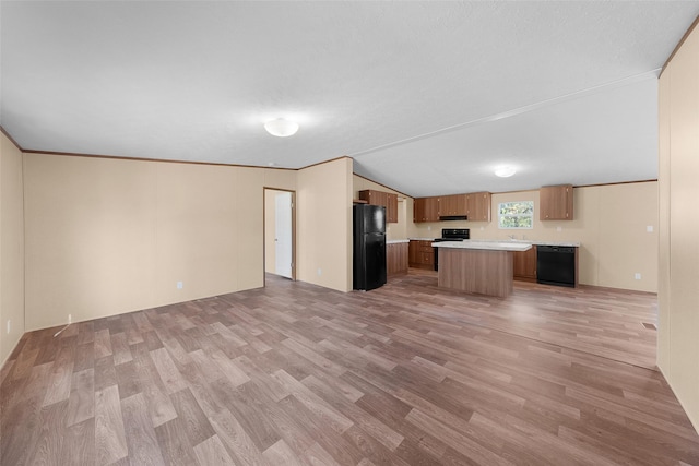 unfurnished living room with light hardwood / wood-style floors, lofted ceiling, and crown molding