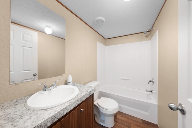 full bathroom featuring toilet, tub / shower combination, hardwood / wood-style floors, and vanity