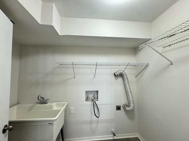 laundry room with washer hookup, a textured ceiling, sink, and electric dryer hookup