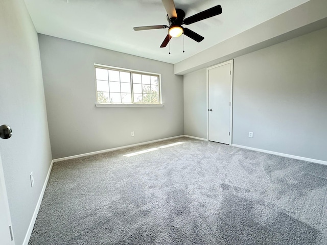 carpeted empty room with ceiling fan