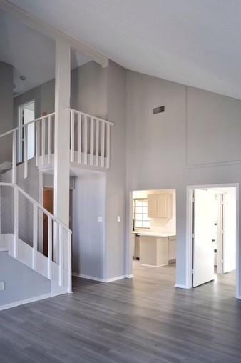 interior space with dark hardwood / wood-style floors and a high ceiling