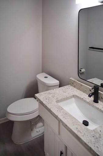 bathroom featuring toilet and vanity