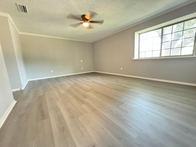 empty room featuring light hardwood / wood-style floors, a textured ceiling, crown molding, and ceiling fan