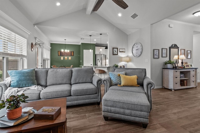 living room with vaulted ceiling with beams, dark hardwood / wood-style flooring, ceiling fan with notable chandelier, and ornamental molding