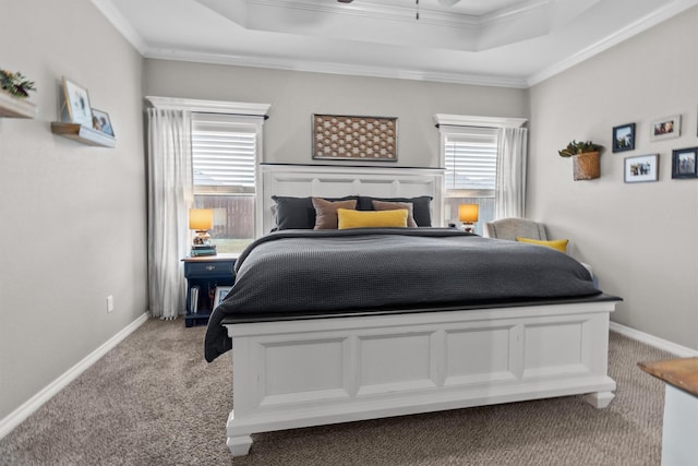 carpeted bedroom featuring a raised ceiling and crown molding