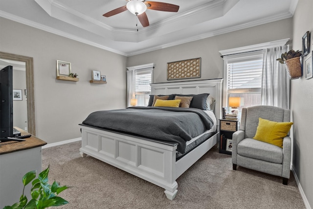 bedroom featuring light carpet, ceiling fan, ornamental molding, and a raised ceiling