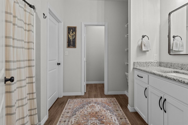 bathroom featuring vanity and hardwood / wood-style flooring