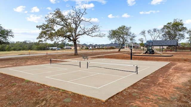 view of tennis court featuring a playground and basketball court