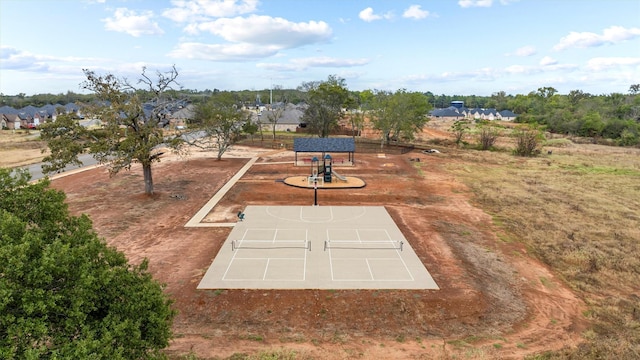 exterior space featuring tennis court and basketball hoop