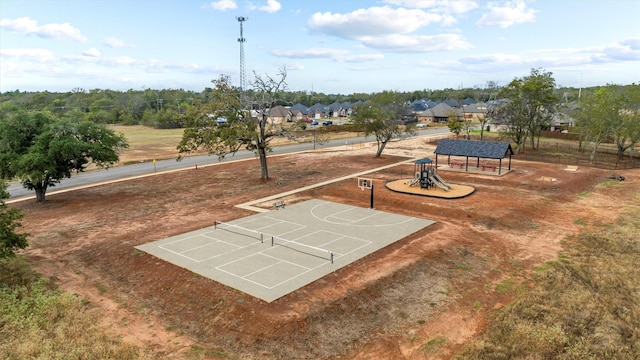 view of property's community with tennis court, basketball hoop, and a playground