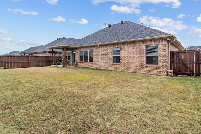 rear view of property with a yard