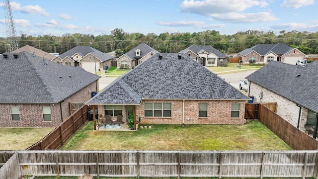 rear view of house featuring a patio area and a lawn