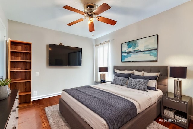 bedroom with ceiling fan and dark hardwood / wood-style floors