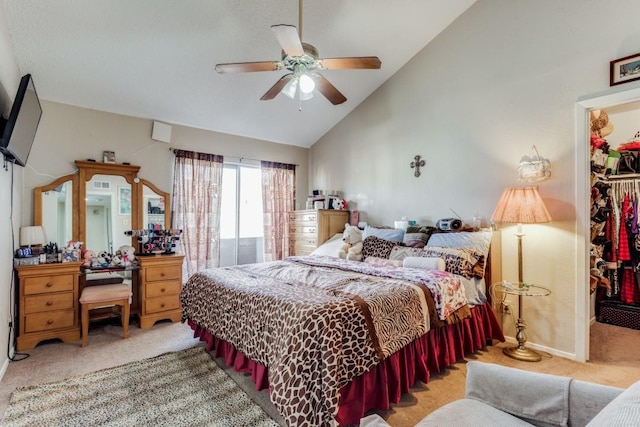 bedroom featuring ceiling fan, a walk in closet, a closet, and carpet