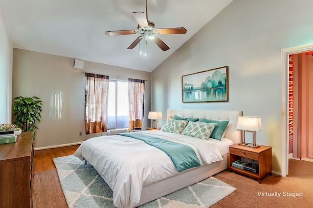 bedroom with ceiling fan, hardwood / wood-style flooring, and high vaulted ceiling