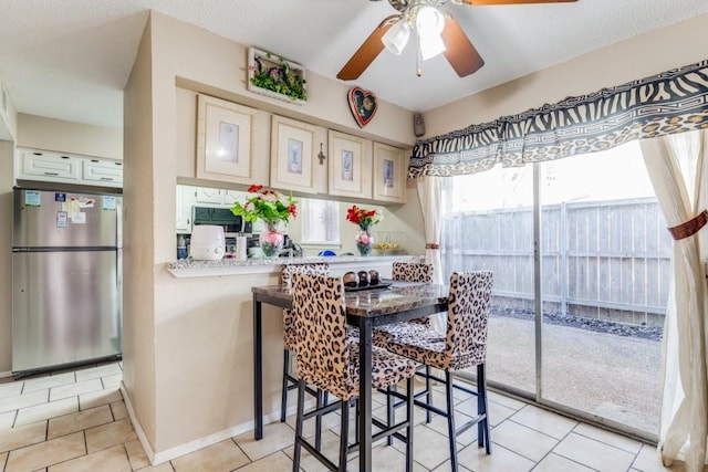 dining room featuring ceiling fan and light tile patterned floors