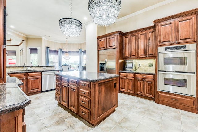 kitchen with a kitchen island, a chandelier, hanging light fixtures, and appliances with stainless steel finishes